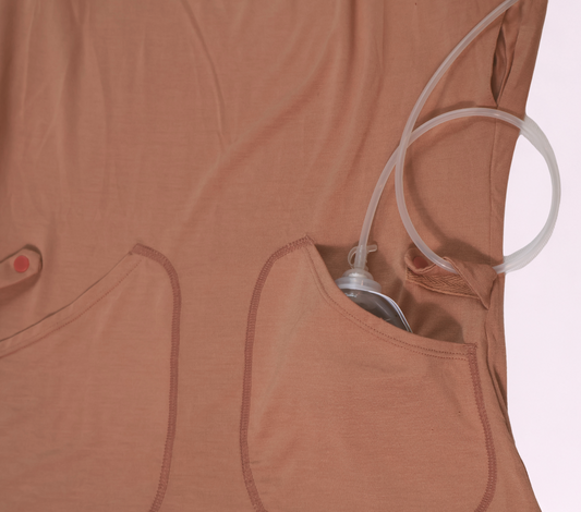 Close-up of a camel Bamboo Recovery Tank showing an interior pocket holding a drain bulb and a snap tab around tubing.